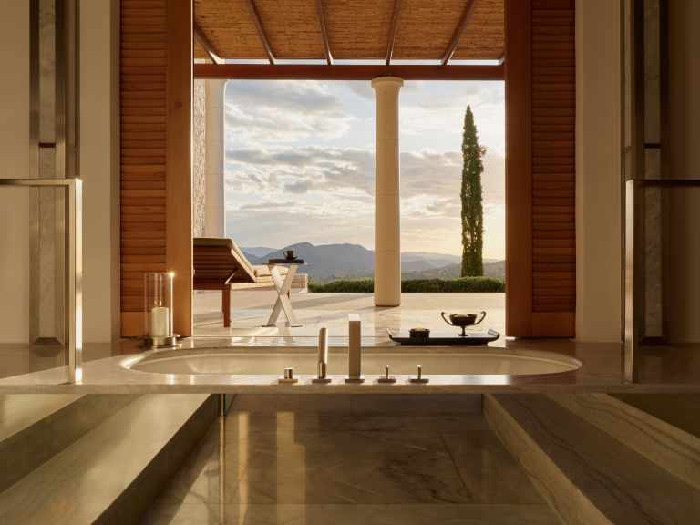 Modern marble bathroom in Amanzoe Greece suite with soaking tub and luxury amenities