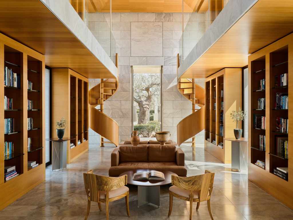 Elegant library at Amanzoe luxury hotel Greece with marble floors and panoramic windows