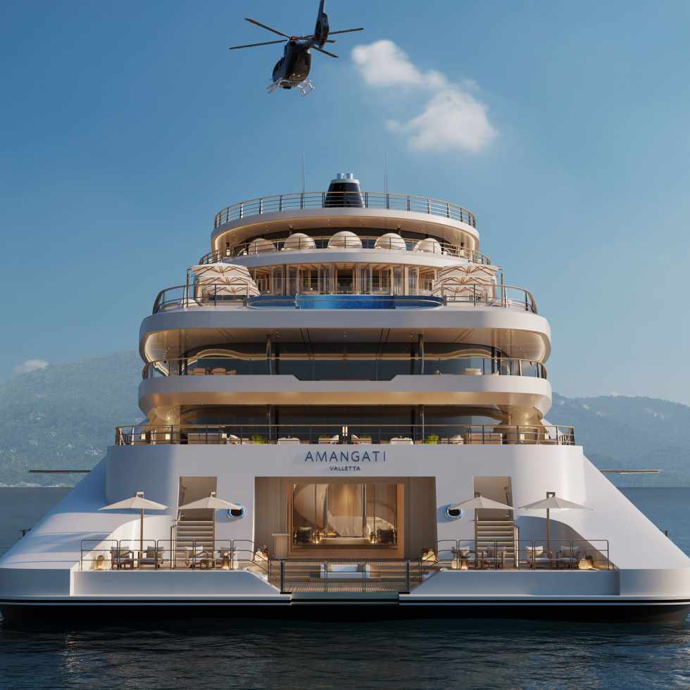 Aman’s new superyacht Amangati at sea with a helicopter flying overhead.