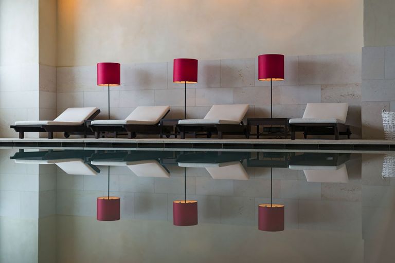 Serene spa area at Almhof Schneider with an indoor pool, natural materials, and a calm alpine wellness atmosphere.