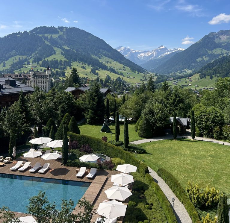 Summer at The Alpina Gstaad — green Alpine landscape overlooking the Bernese Oberland Switzerland