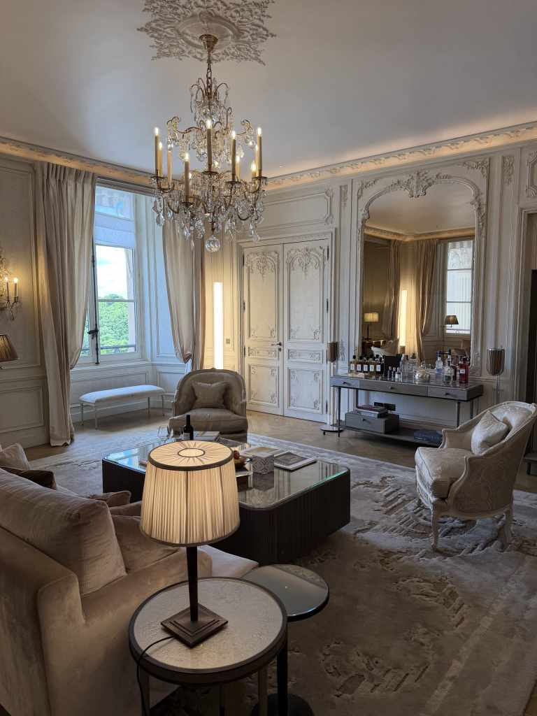 Interior of the Karl Lagerfeld-designed Les Grands Appartements at Hôtel de Crillon in Paris, showcasing refined contemporary luxury with sculptural furniture, monochrome accents, high ceilings, and a sophisticated blend of historic Parisian architecture and modern design.
